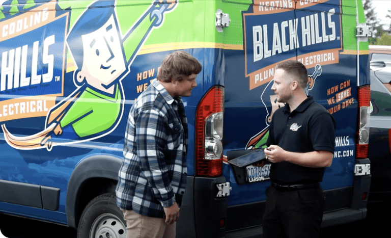 Black Hills employees next to van