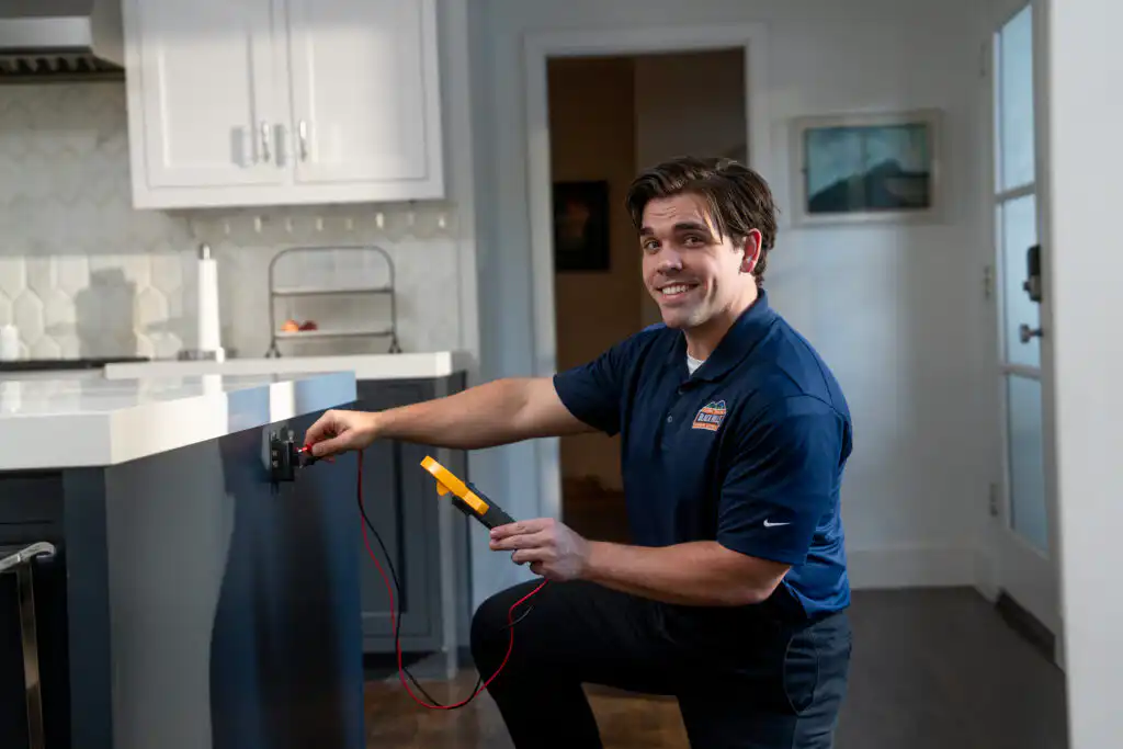 plumber working on kitchen plumbing