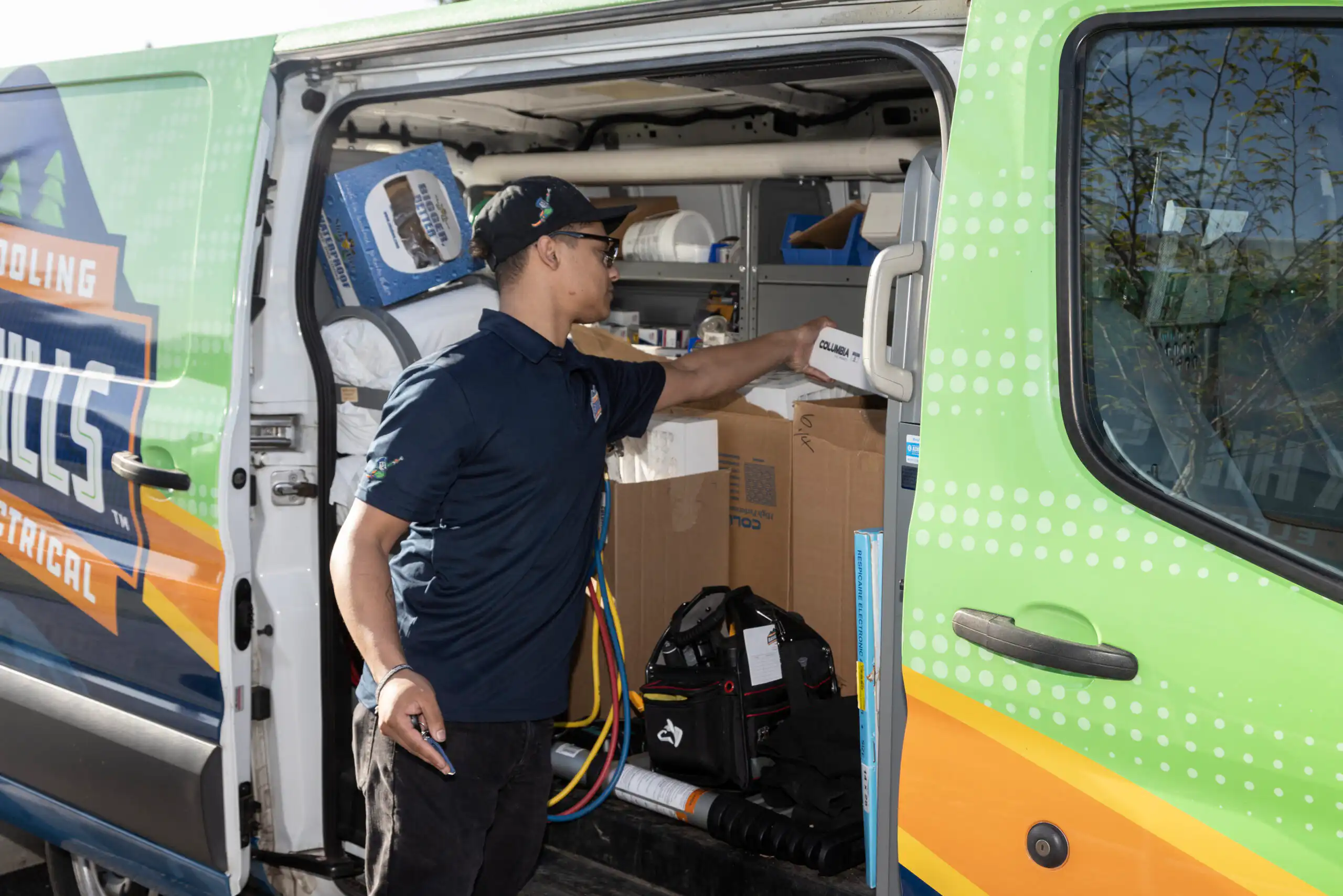 plumber pulling out equipment from van