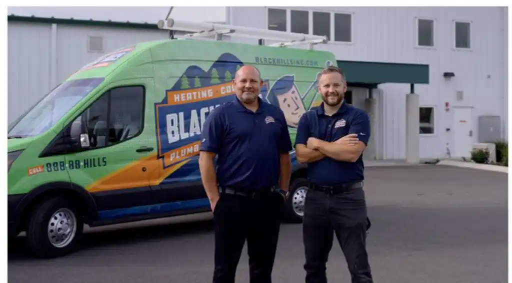 Travis Guthrie standing in front of Black Hills Van