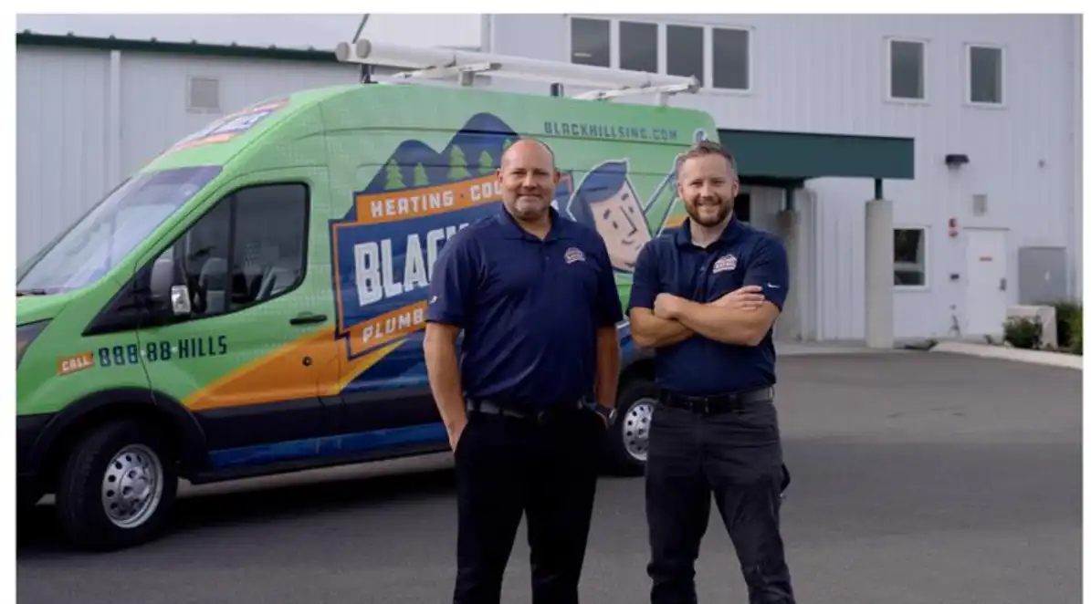 Travis Guthrie standing in front of Black Hills Van